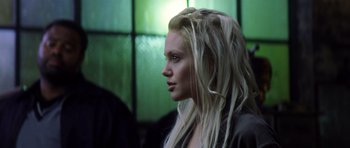 Movie still from “Gone in 60 Seconds” (2000), directed by Dominic Sena – A woman with long blonde hair looking to the side; Close Up shot, Over the shoulder angle