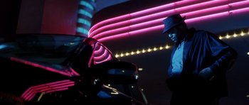 Movie still from “Gone in 60 Seconds” (2000), directed by Dominic Sena – A man standing in front of a motorcycle at night; Wide shot, Low angle