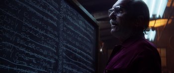 Movie still from “Gone in 60 Seconds” (2000), directed by Dominic Sena – A man standing in front of a blackboard; Close Up shot, Over the shoulder angle
