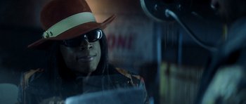 Movie still from “Gone in 60 Seconds” (2000), directed by Dominic Sena – A man wearing a hat and sunglasses in a car; Close Up shot, Low angle