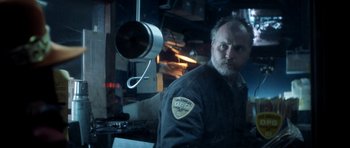 Movie still from “Gone in 60 Seconds” (2000), directed by Dominic Sena – A man standing in front of a mirror in a room; Close Up shot, Low angle