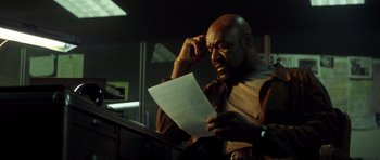 Movie still from “Gone in 60 Seconds” (2000), directed by Dominic Sena – A bald man is reading a piece of paper; Close Up shot, Low angle