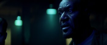 Movie still from “Gone in 60 Seconds” (2000), directed by Dominic Sena – A man's face in a dark room; Close Up shot, Low angle