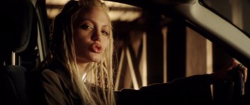 Movie still from “Gone in 60 Seconds” (2000), directed by Dominic Sena – A woman with long blonde hair is posing for a picture; Close Up shot, Low angle