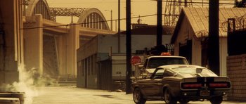 Movie still from “Gone in 60 Seconds” (2000), directed by Dominic Sena – A street scene with a stop sign and a car; Extreme Wide shot, Low angle