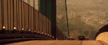 Movie still from “Gone in 60 Seconds” (2000), directed by Dominic Sena – A police car is parked on the side of a bridge; Extreme Wide shot, Low angle