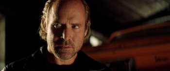 Movie still from “Gone in 60 Seconds” (2000), directed by Dominic Sena – A person wearing a black shirt; Close Up shot, Over the shoulder angle