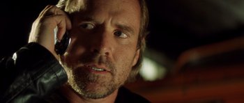 Movie still from “Gone in 60 Seconds” (2000), directed by Dominic Sena – A man's face in a dimly - lit room; Close Up shot, Low angle