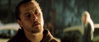 Movie still from “Gone in 60 Seconds” (2000), directed by Dominic Sena – A person with a beard looking to his left; Close Up shot, Low angle