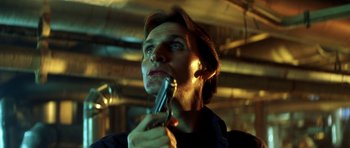 Movie still from “Gone in 60 Seconds” (2000), directed by Dominic Sena – A man holding a gun up to his face; Close Up shot, Low angle