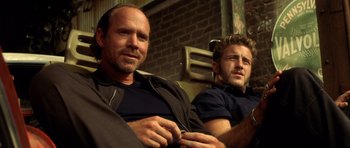 Movie still from “Gone in 60 Seconds” (2000), directed by Dominic Sena – A couple of men sitting next to each other; Close Up shot, Low angle