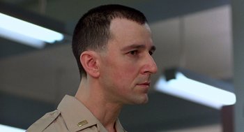 Movie still from “Good Morning, Vietnam” (1987), directed by Barry Levinson – A person wearing a military uniform; Close Up shot, Low angle