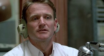 Movie still from “Good Morning, Vietnam” (1987), directed by Barry Levinson – A person wearing headphones; Close Up shot, Low angle