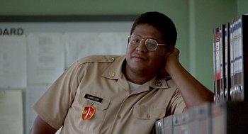 Movie still from “Good Morning, Vietnam” (1987), directed by Barry Levinson – A man in a military uniform with glasses on; Close Up shot, Low angle