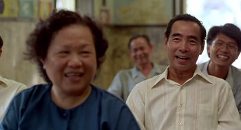 Movie still from “Good Morning, Vietnam” (1987), directed by Barry Levinson – A group of people standing next to each other in a room; Medium shot, Over the shoulder angle