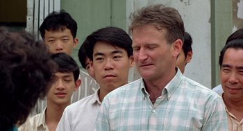 Movie still from “Good Morning, Vietnam” (1987), directed by Barry Levinson – A group of men standing next to each other; Close Up shot, Over the shoulder angle