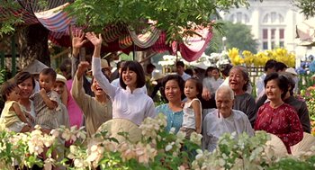 Movie still from “Good Morning, Vietnam” (1987), directed by Barry Levinson – A group of people standing next to each other under a tree; Medium shot, Low angle