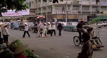 Movie still from “Good Morning, Vietnam” (1987), directed by Barry Levinson – A group of people walking down a street; Extreme Wide shot, High angle