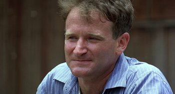 Movie still from “Good Morning, Vietnam” (1987), directed by Barry Levinson – A person wearing a blue striped shirt; Close Up shot, Low angle