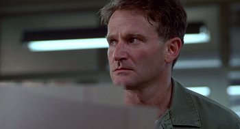 Movie still from “Good Morning, Vietnam” (1987), directed by Barry Levinson – A person looking at something; Close Up shot, Low angle