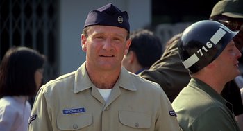 Movie still from “Good Morning, Vietnam” (1987), directed by Barry Levinson – A person wearing a uniform; Close Up shot, Over the shoulder angle