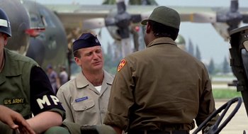 Movie still from “Good Morning, Vietnam” (1987), directed by Barry Levinson – A man in a uniform talking to another man in a uniform; Medium shot, Over the shoulder angle