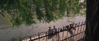Movie still from “To the Wonder” (2012), directed by Terrence Malick – Two people sitting on the side of a river; Extreme Wide shot, High angle