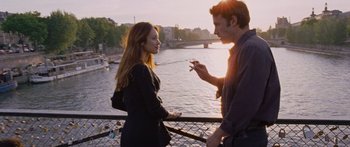 Movie still from “To the Wonder” (2012), directed by Terrence Malick – A man and a woman standing next to each other on a bridge; Medium shot, Over the shoulder angle