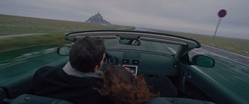 Movie still from “To the Wonder” (2012), directed by Terrence Malick – A man and a woman in a car looking out the window; Wide shot, High angle