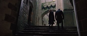 Movie still from “To the Wonder” (2012), directed by Terrence Malick – A couple of people that are walking up some stairs; Wide shot, High angle