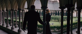Movie still from “To the Wonder” (2012), directed by Terrence Malick – A man and a woman holding hands in a courtyard; Wide shot, Low angle