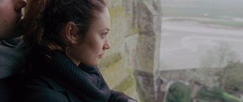 Movie still from “To the Wonder” (2012), directed by Terrence Malick – A woman looking out of a window at a stone wall; Close Up shot, Over the shoulder angle