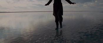 Movie still from “To the Wonder” (2012), directed by Terrence Malick – A person standing in the middle of a body of water; Wide shot, Low angle