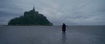 Movie still from “To the Wonder” (2012), directed by Terrence Malick – Two people standing in the water near a castle; Extreme Wide shot, Low angle