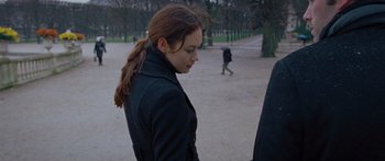 Movie still from “To the Wonder” (2012), directed by Terrence Malick – A young woman in a black jacket is looking down; Medium shot, Over the shoulder angle