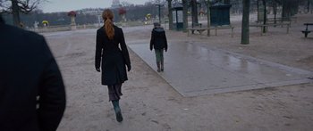 Movie still from “To the Wonder” (2012), directed by Terrence Malick – Two people are walking down the sidewalk in the rain; Wide shot, Low angle