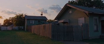 Movie still from “To the Wonder” (2012), directed by Terrence Malick – A wooden fence in front of a wooden house; Extreme Wide shot, Low angle