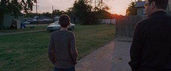 Movie still from “To the Wonder” (2012), directed by Terrence Malick – A boy standing on the side of the road watching the sun go down; Wide shot, Over the shoulder angle