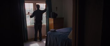 Movie still from “To the Wonder” (2012), directed by Terrence Malick – A man standing in front of a window in a room; Wide shot, Low angle