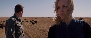 Movie still from “To the Wonder” (2012), directed by Terrence Malick – A woman standing in front of a herd of cattle; Close Up shot, Over the shoulder angle
