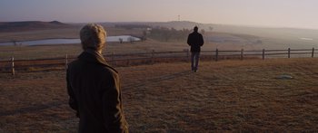 Movie still from “To the Wonder” (2012), directed by Terrence Malick – Two people are standing in a field near a fence; Extreme Wide shot, Over the shoulder angle
