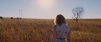 Movie still from “To the Wonder” (2012), directed by Terrence Malick – A woman standing in the middle of an open field; Wide shot, Low angle