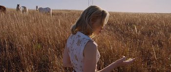 Movie still from “To the Wonder” (2012), directed by Terrence Malick – A woman standing in the middle of an open field; Medium shot, Low angle
