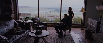 Movie still from “To the Wonder” (2012), directed by Terrence Malick – A man and a woman sitting in front of a large window; Wide shot, Over the shoulder angle