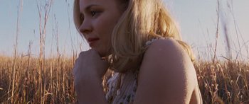 Movie still from “To the Wonder” (2012), directed by Terrence Malick – A beautiful young blonde haired woman in a field; Close Up shot, Low angle