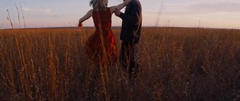 Movie still from “To the Wonder” (2012), directed by Terrence Malick – A man and a woman dancing in a field; Wide shot, Low angle