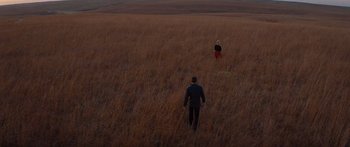 Movie still from “To the Wonder” (2012), directed by Terrence Malick – A man and a woman in a field flying a kite; Extreme Wide shot, High angle