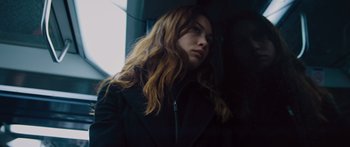 Movie still from “To the Wonder” (2012), directed by Terrence Malick – A woman with long brown hair wearing a black jacket; Close Up shot, Low angle
