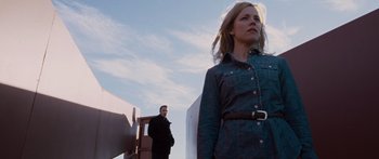 Movie still from “To the Wonder” (2012), directed by Terrence Malick – A man and a woman standing next to each other in front of a truck; Medium shot, Low angle