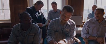 Movie still from “To the Wonder” (2012), directed by Terrence Malick – A group of men sitting in a room; Medium shot, High angle